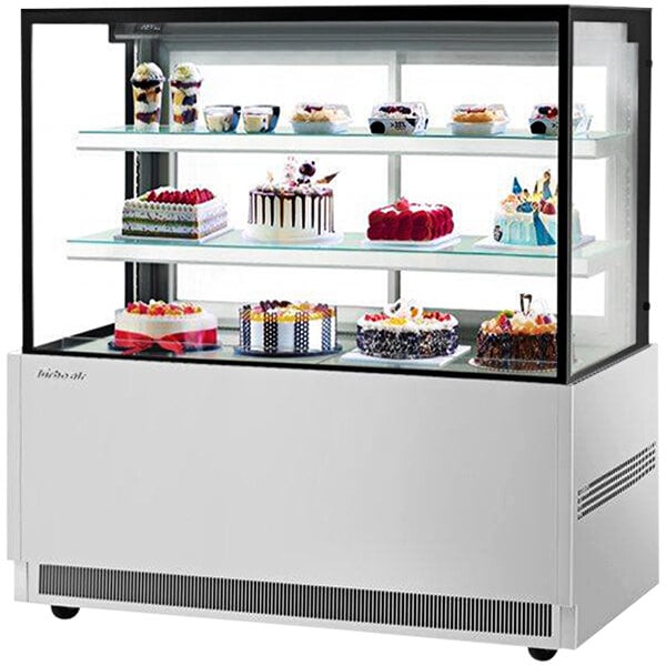 A Turbo Air refrigerated bakery display case with cakes on shelves.