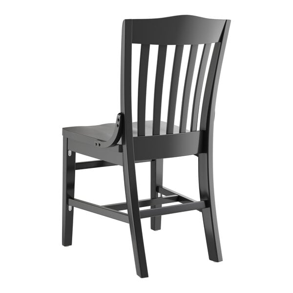 A Lancaster Table & Seating black wood school house chair with a wooden seat and back.