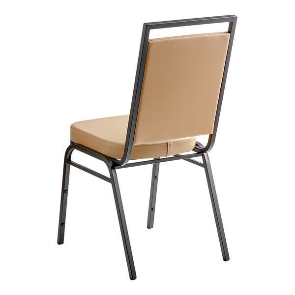 A tan Lancaster Table & Seating banquet chair with black metal legs.