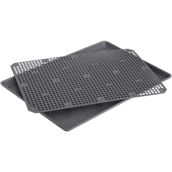 A LloydPans oven roaster set with trays that have holes in them.