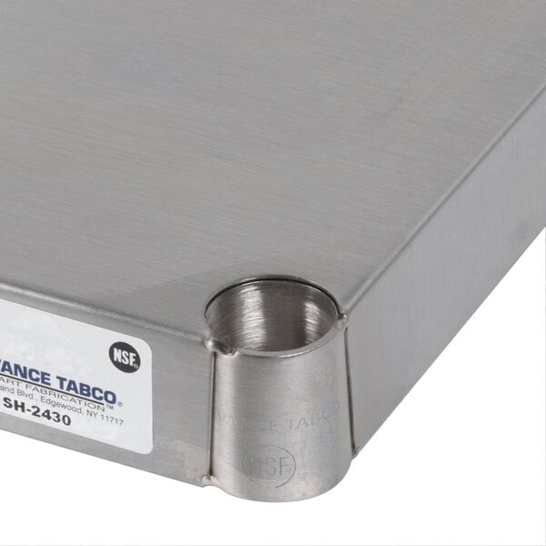 A close-up of a solid stainless steel shelf surface.