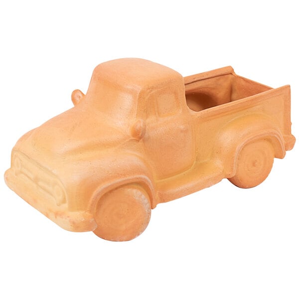 A terracotta truck shaped like a car on a white background.