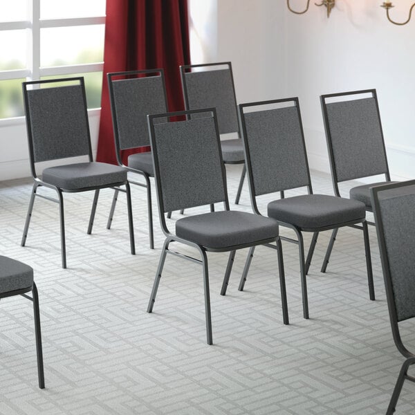 Lancaster Table & Seating Square Back Banquet Chairs with Gray Fabric and Black Frames in a room
