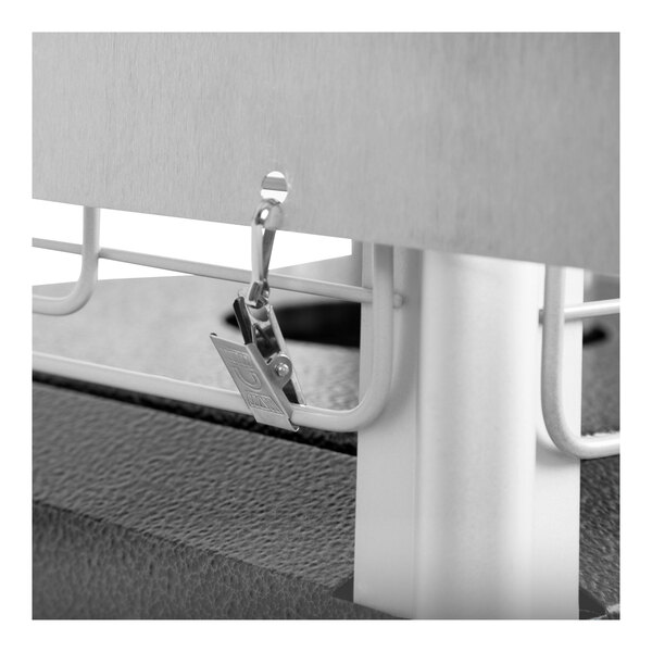 A metal clip attached to a metal bar.