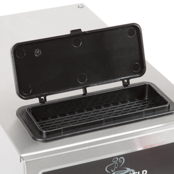 A black rectangular plastic lid with holes on a silver Bloomfield coffee brewer.