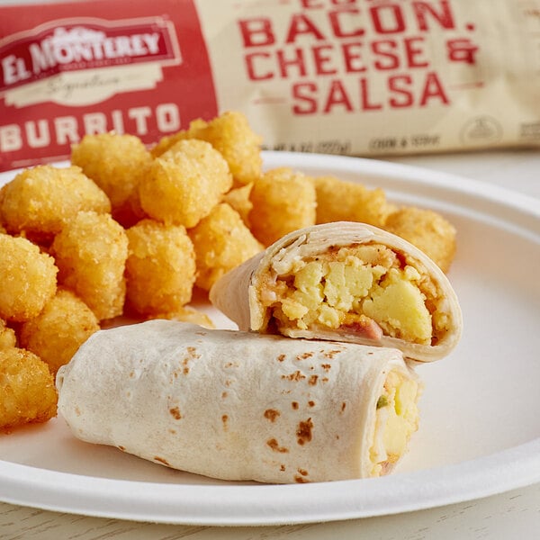 A plate of food with an El Monterey breakfast burrito, eggs, and tater tots.