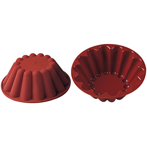 A red Silikomart silicone baking mold with a lid.