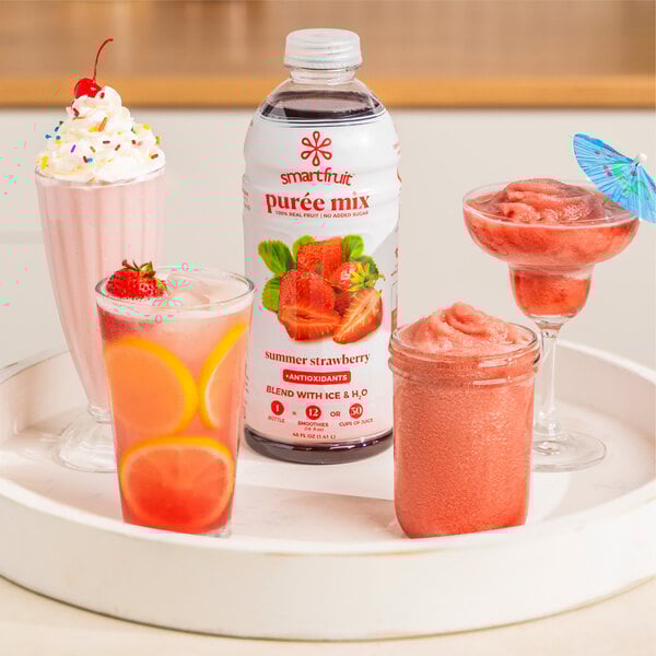 A tray of glasses with Smartfruit Summer Strawberry puree and ice.