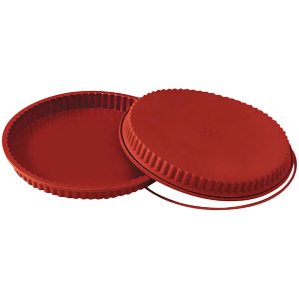 A red round baking dish with a lid.