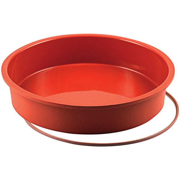 A red round Silikomart silicone baking mold.