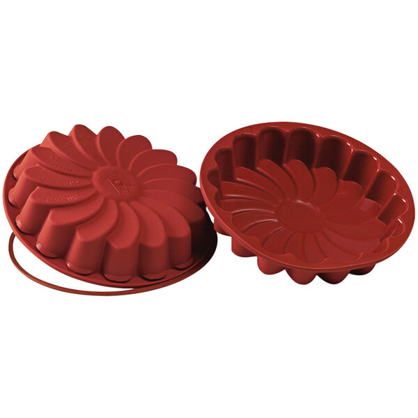 A red Silikomart Daisy silicone baking mold with a loop.