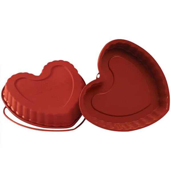 A red Silikomart heart-shaped baking mold with a lid.