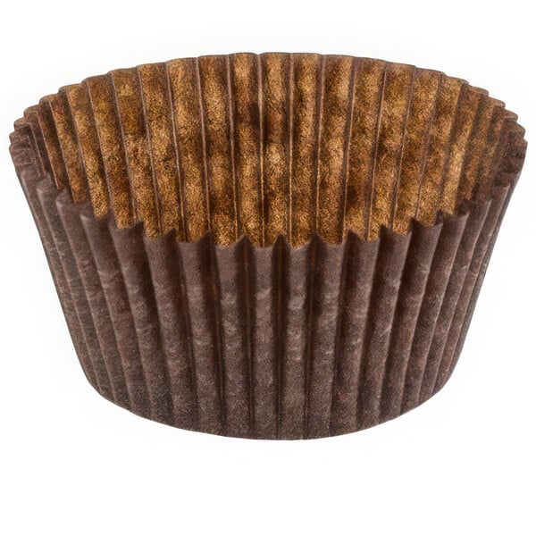 A close-up of a brown paper Novacart fluted baking cup with a brown rim.