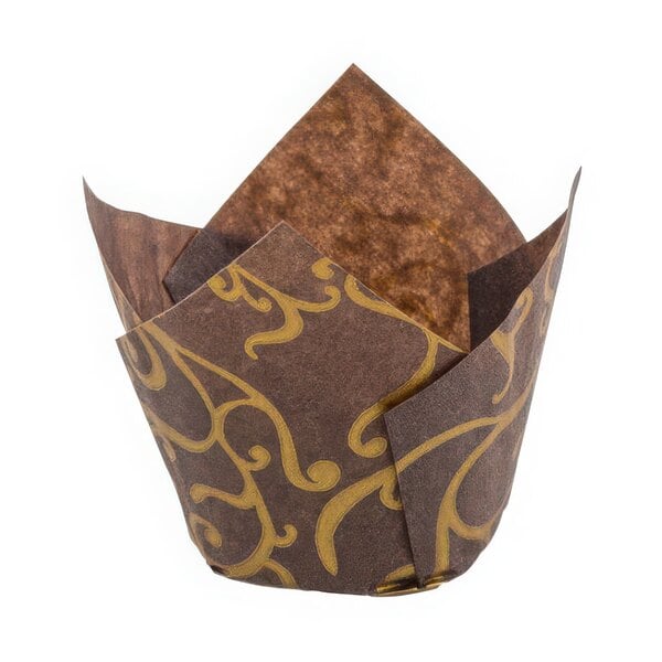 A brown paper baking cup with gold tulip designs.