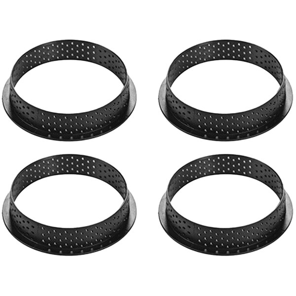 Four black metal Silikomart tart rings with holes on them.
