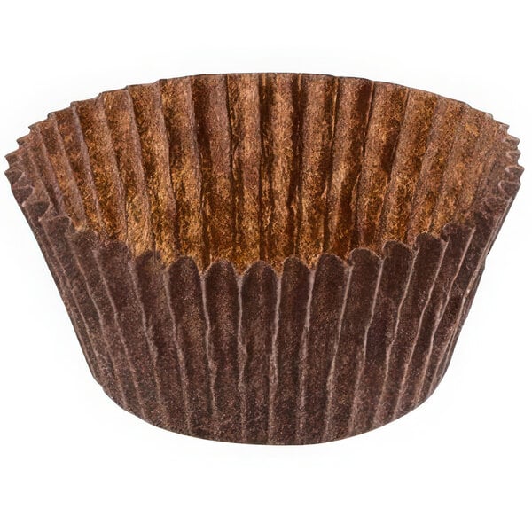 A close-up of a brown Novacart fluted baking cup with a brown rim.