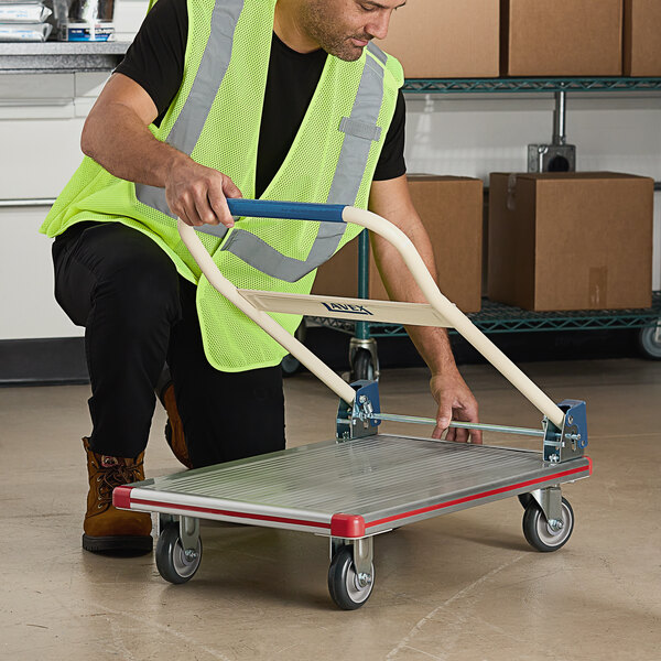A man folding the Lavex aluminum plarform truck.