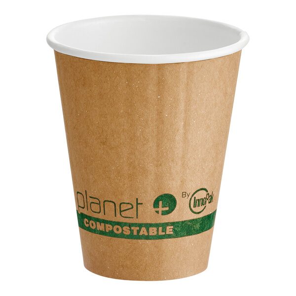 A brown compostable double wall paper hot cup with green labeling and a white interior.