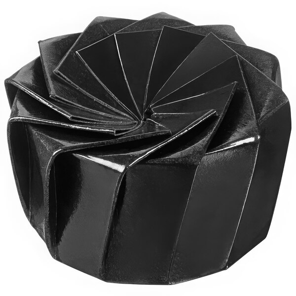 A black Solia origami bowl with a spiral pattern.
