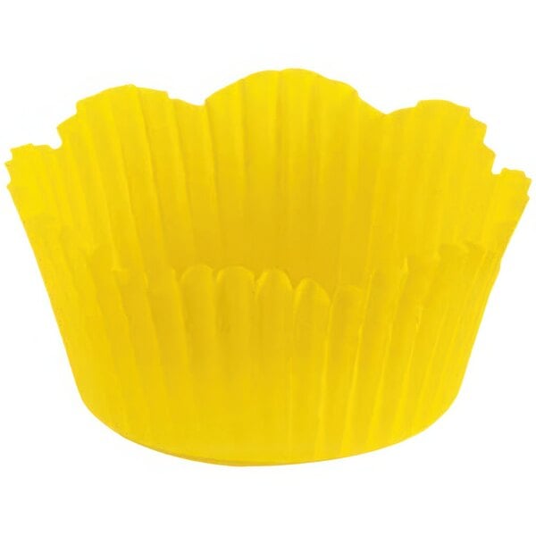 A close up of a yellow Novacart fluted baking cup with a white background.