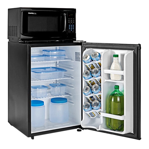 A black Danby mini fridge with a door open and a water bottle inside.