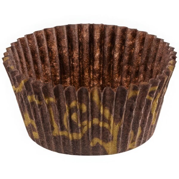 A brown paper Novacart cupcake liner with gold and brown designs.