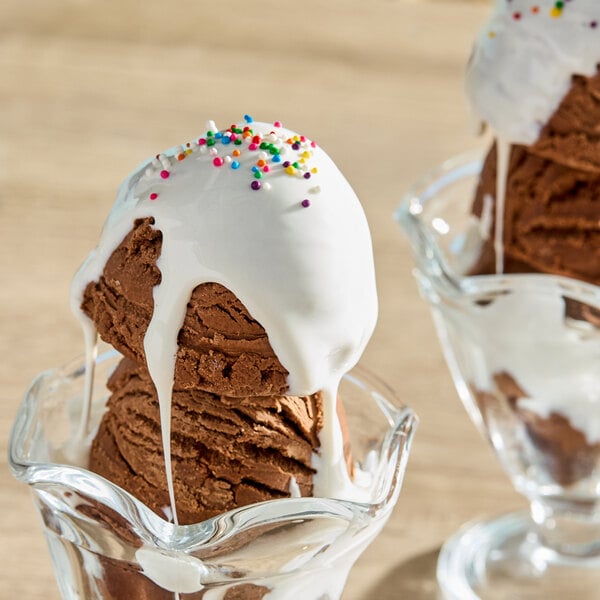 A close up of a chocolate ice cream sundae with white marshmallow topping.