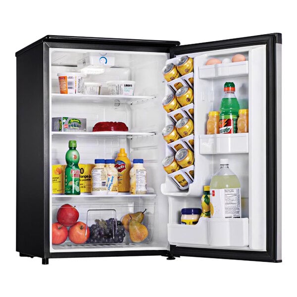 A Danby stainless steel hotel refrigerator full of food.