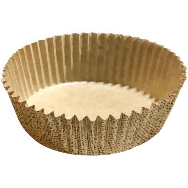 A close up of a brown Novacart paper baking cup with fluted edges.