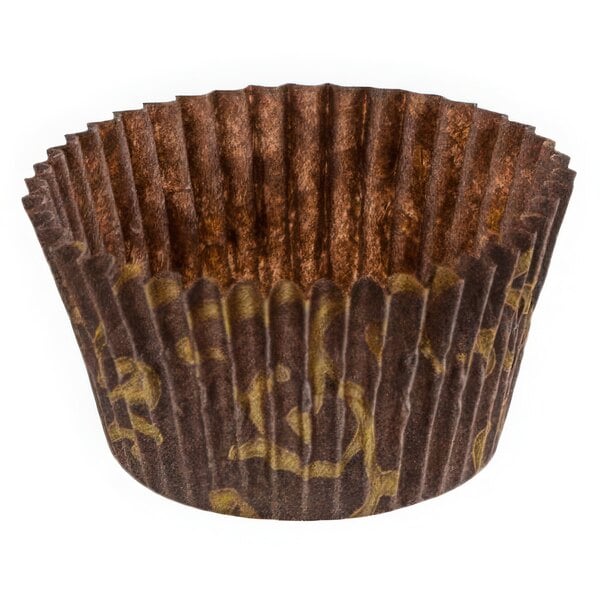 A brown paper cupcake wrapper with gold designs.