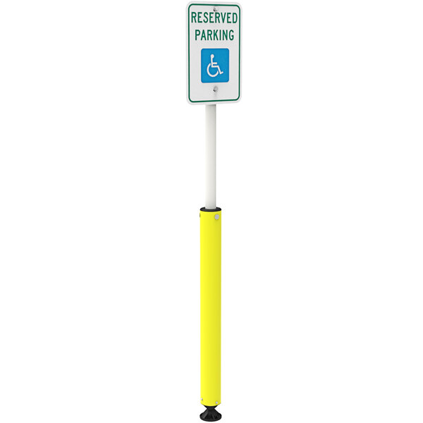 A yellow cylindrical bollard with a "Handicapped Reserved Parking" sign on it.