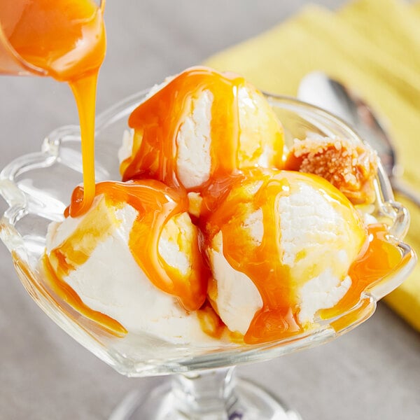 A bowl of ice cream with Oringer Salty Caramel Dessert Topping.