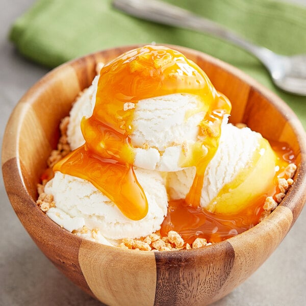 A bowl of Oringer butterscotch dessert topping on a scoop of ice cream.