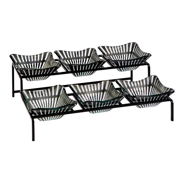 A black metal Rosseto Kalderon Stelo condiment stand with glass bowls on it.