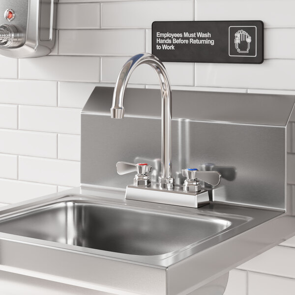 A stainless steel sink with a 6-inch long swivel gooseneck spout and dual handles, mounted against a tiled wall.
