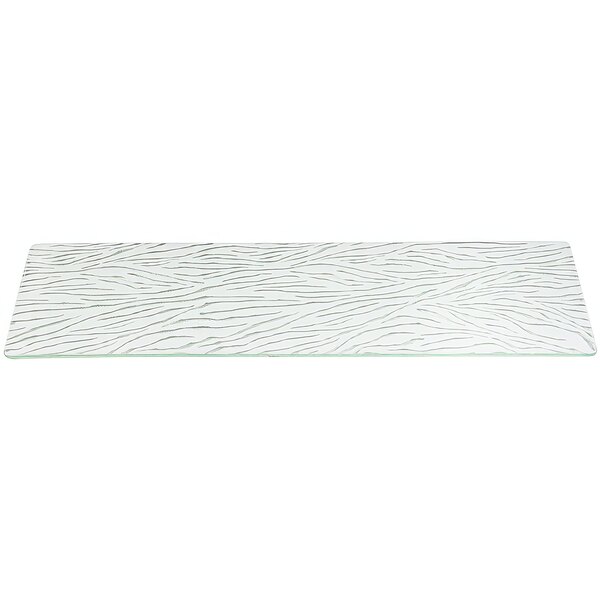 A rectangular white glass shelf with a pattern on it.