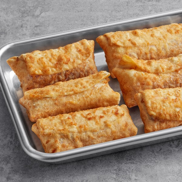 A tray of El Monterey Raspberry Cheesecake Chimis in a pan.