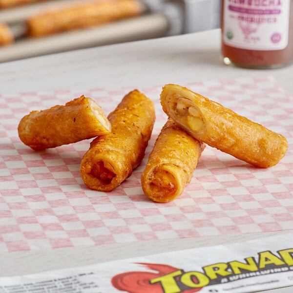 Ruiz Foods Sausage, Egg, & Cheese Taquito sticks on a paper.