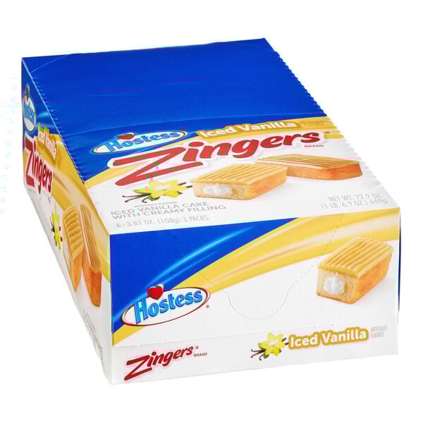 A blue and yellow box of Hostess Zingers Single Serve Iced Vanilla Cake.