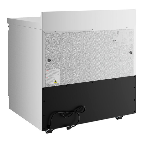 An Avantco white and black worktop refrigerator with the door open.