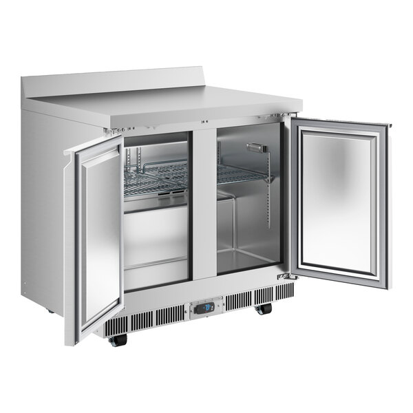 An Avantco stainless steel worktop freezer with two doors open.