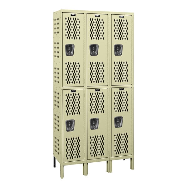 A group of tan Hallowell triple 2-tier ventilated lockers with three doors and two holes.