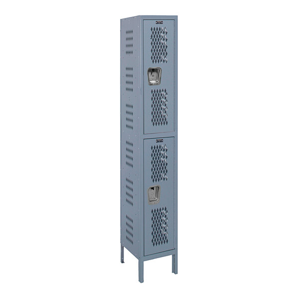 A close-up of a tall gray metal Hallowell locker with two compartments and holes in the door.
