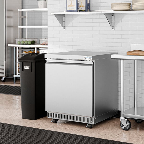 An Avantco ZUC-27R-HC stainless steel undercounter refrigerator in a kitchen.