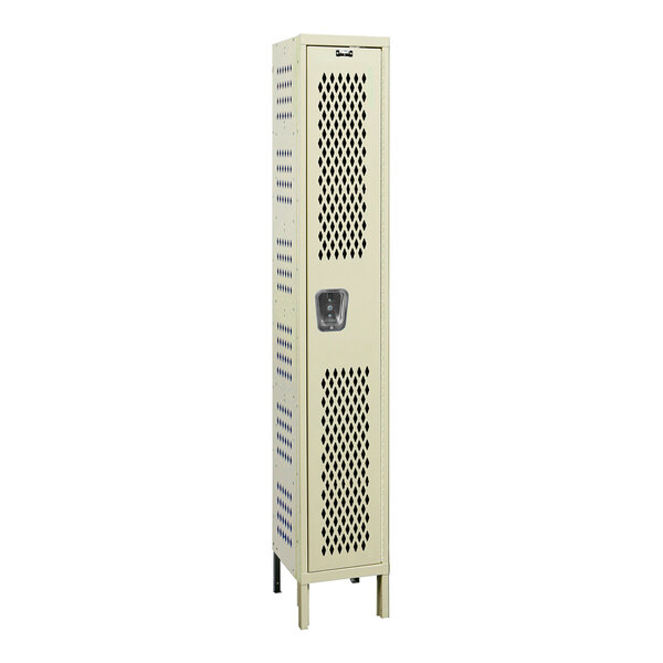 A tall tan metal locker with holes in it.