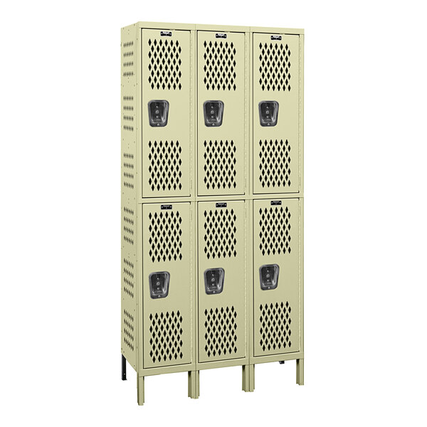 A group of tan Hallowell triple 2-tier ventilated wardrobe lockers with three doors.