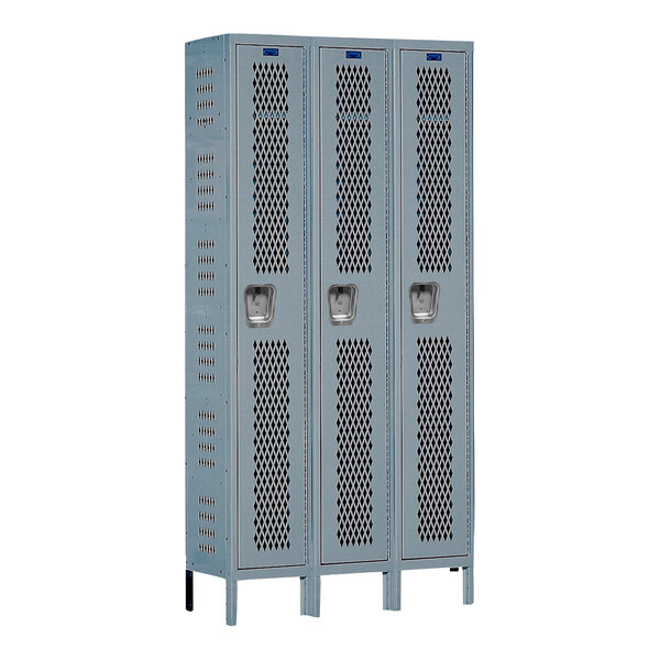 Two unassembled gray Hallowell metal lockers with ventilation holes.