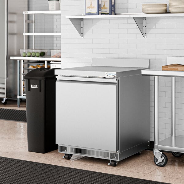 An Avantco stainless steel worktop refrigerator in a kitchen.