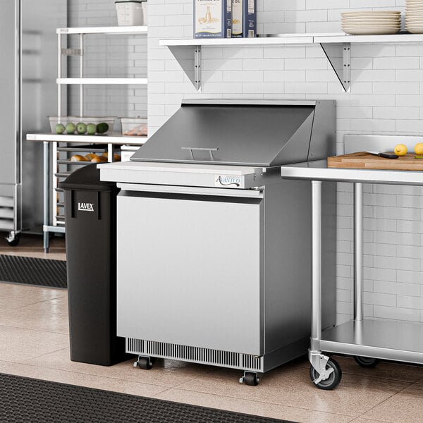 An Avantco stainless steel mega top sandwich prep table on a counter in a professional kitchen.