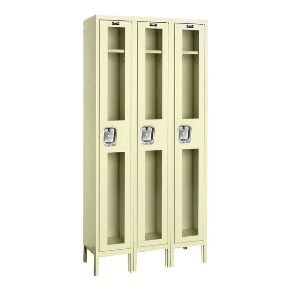 A tan Hallowell triple 1-tier wardrobe locker with glass doors.